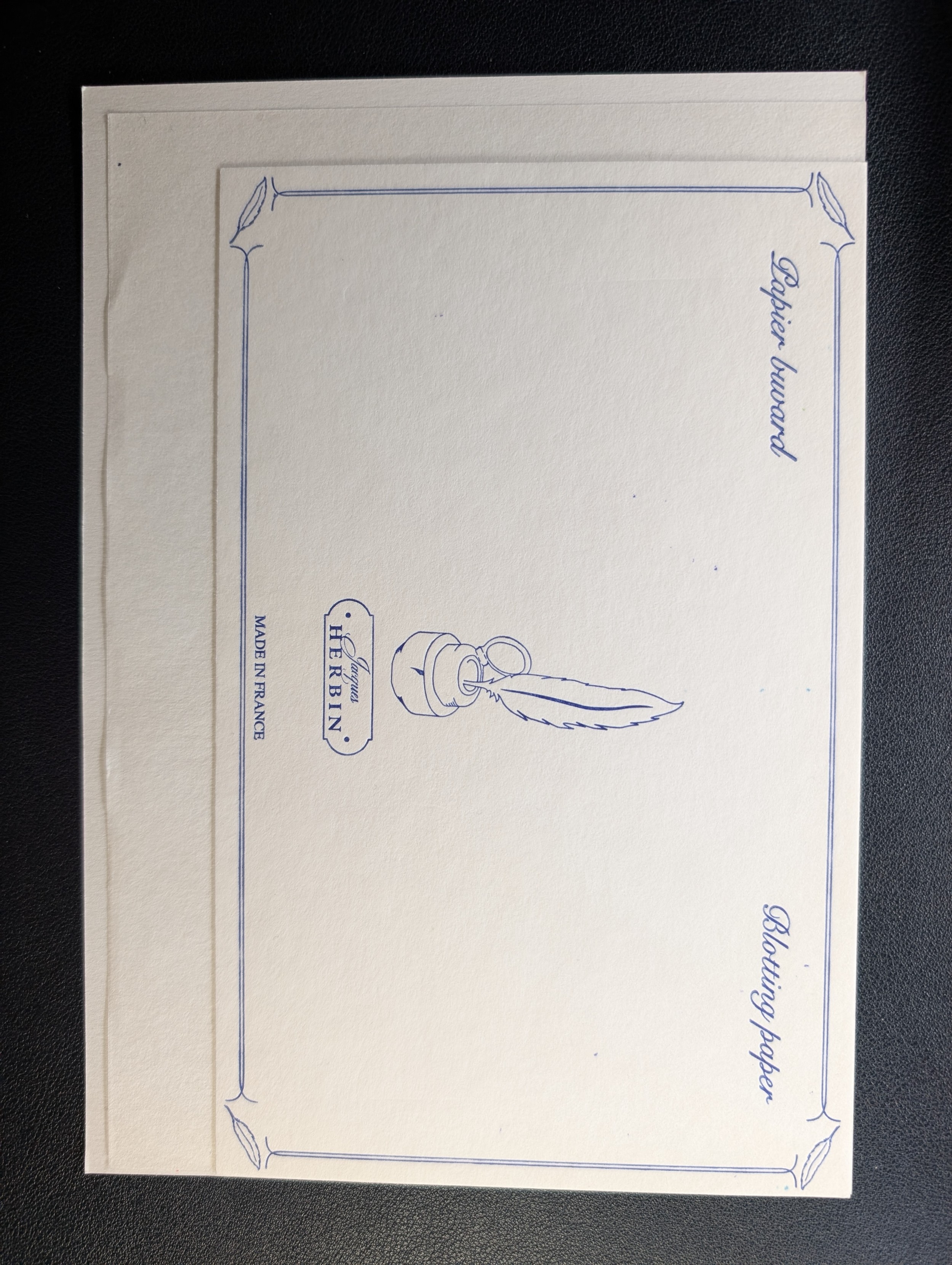 Photo of three sheets of blotting paper aligned to the bottom right. The Herbin on top is the smallest. The Sakae paper behind that is a bit taller and much wider. The Kanso paper in the very back is slightly taller and wider than the Sakae paper.
