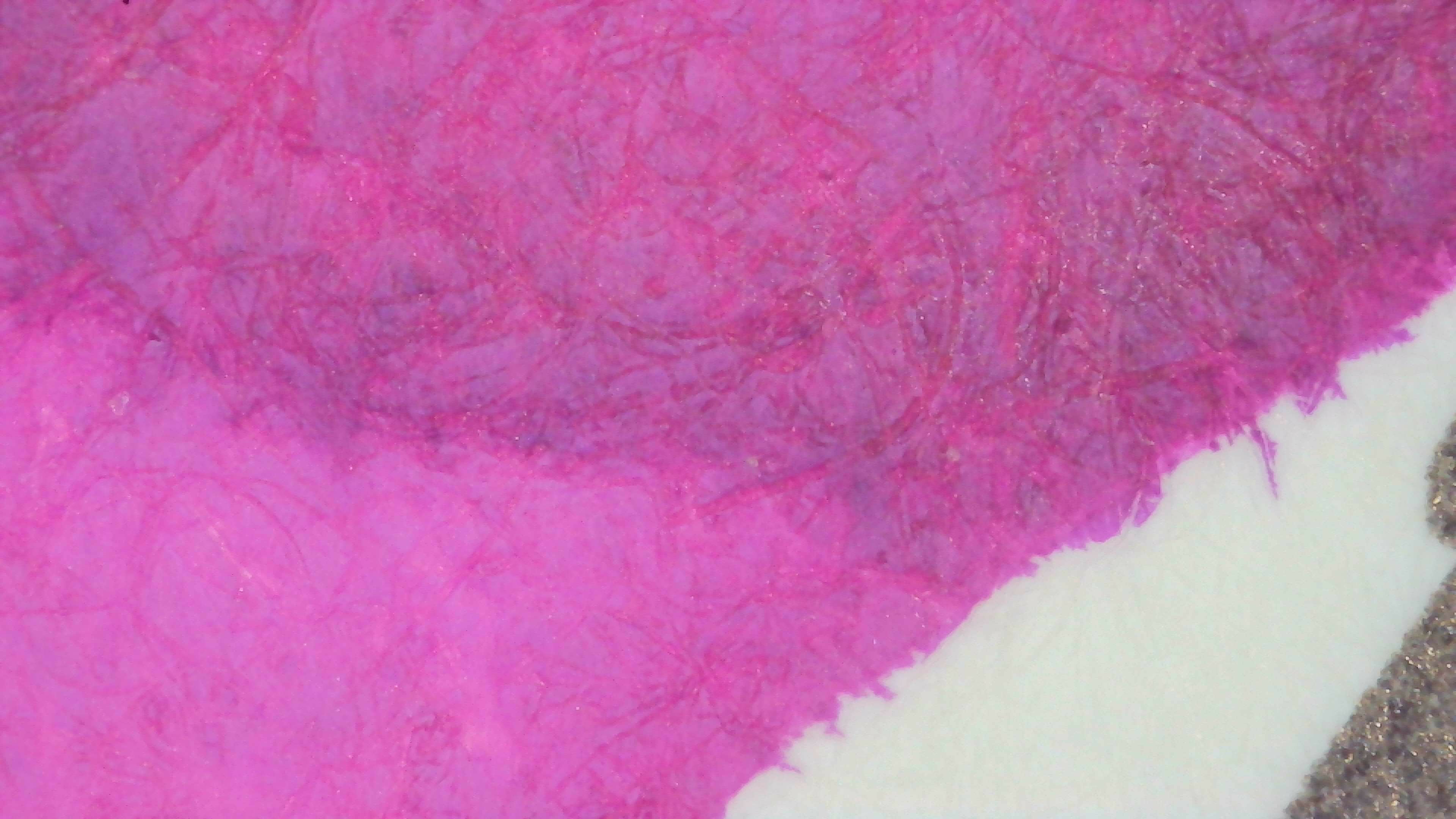 Photo of an ink swatch under magnification. There are two areas, one lighter and one darker. The lighter area is similar to photo 1, while the second is a darker magenta.