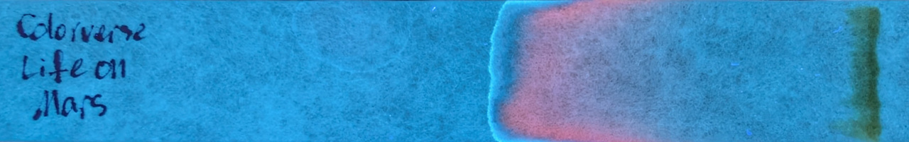 Photo of chromatography paper under UV light.