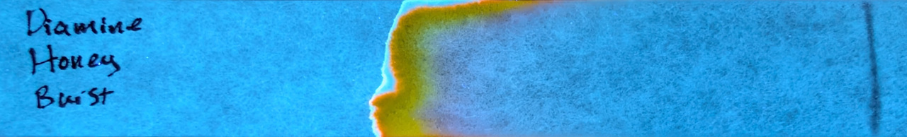 Photo of chromatography paper under UV light.