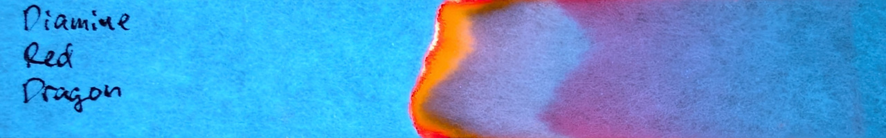 Photo of chromatography paper under UV light.