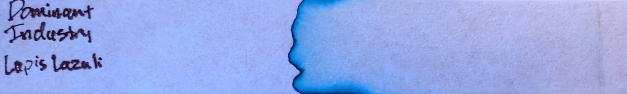Photo of chromatography paper under UV light.