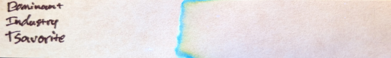 Photo of chromatography paper under UV light.