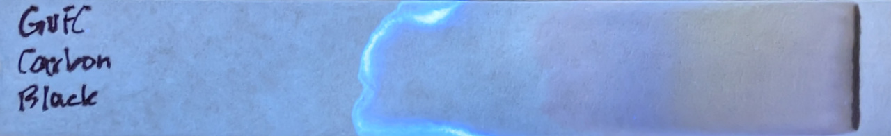 Photo of chromatography paper under UV light.