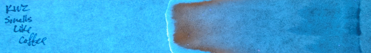 Photo of chromatography paper under UV light.