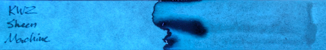 Photo of chromatography paper under UV light.