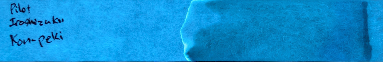 Photo of chromatography paper under UV light.