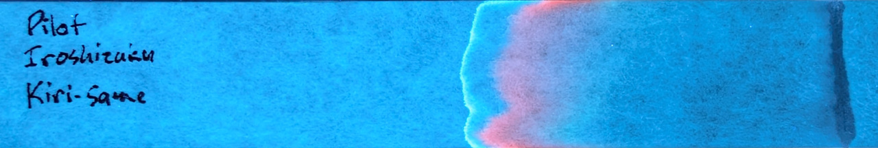 Photo of chromatography paper under UV light.
