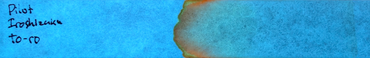 Photo of chromatography paper under UV light.