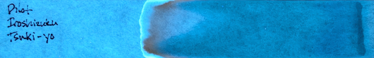 Photo of chromatography paper under UV light.