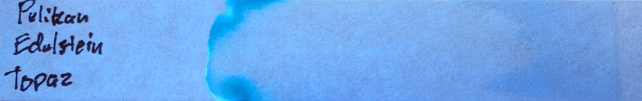 Photo of chromatography paper under UV light.
