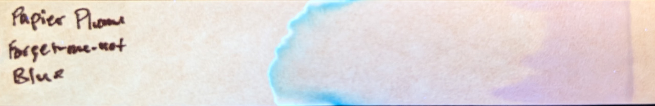 Photo of chromatography paper under UV light.