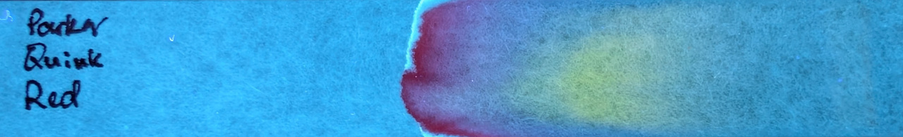 Photo of chromatography paper under UV light.