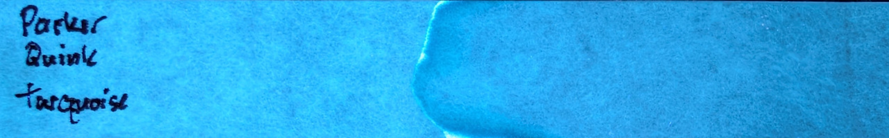 Photo of chromatography paper under UV light.