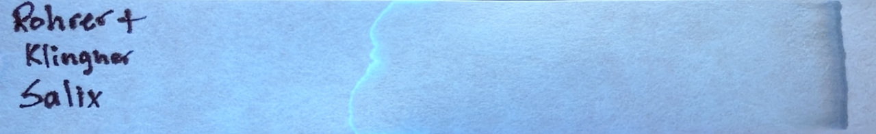 Photo of chromatography paper under UV light.