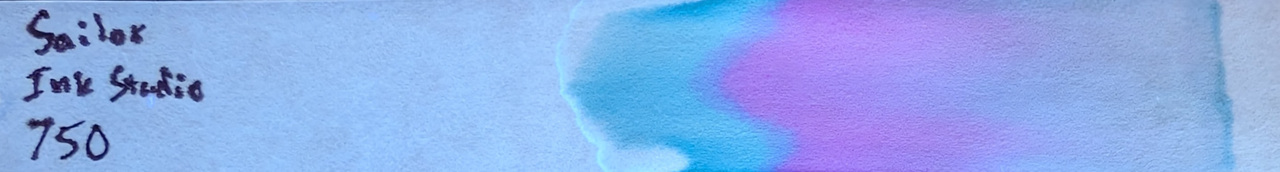 Photo of chromatography paper under UV light.
