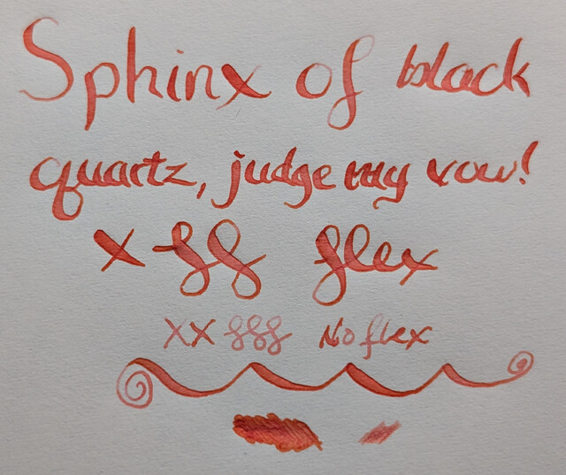 Top-down photo of ink writing and scribbles on MD paper. The ink is a dark coral shade, almost red-orange.  At the top large words were made with a flex nib and reads "Sphinx of black quartz, judge my vow!" followed by an "X" and curlicues and then the word "flex" in cursive. The widest parts of the curlicues and the flex letters have a little hint of pink in them.  Under that is "XX" and three curlicues in a much narrower line that says "no flex", which appears to be a lighter coral.  Under that are a large looping line and two different scribble puddles (flex, no flex)