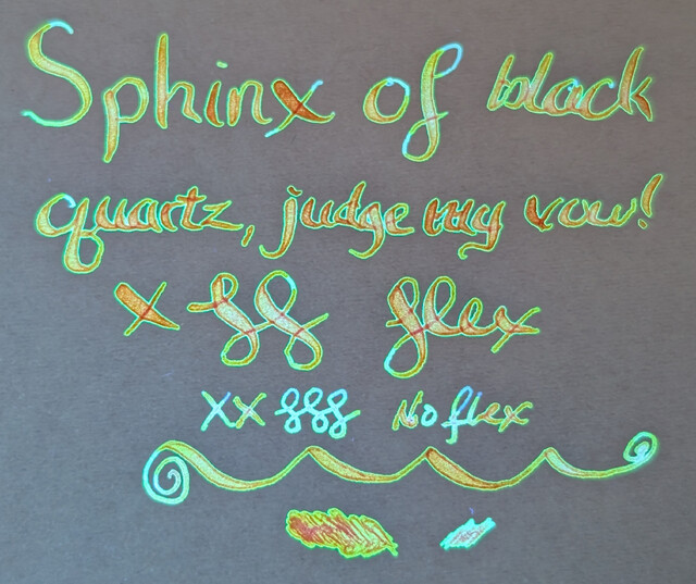 Same as previous photo but under a mix of visible and UV light. The text appears to be glowing orange with a green halo/outline around each letter. Some more narrow sections of letters are glowing light blue.  The "no flex" writing is mostly blue, but still has some orange parts.
