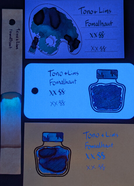 Same as the first image, but under UV light.  The Iroful card paper is glowing dark blue, the ink is glowing dark blue with a hint of green.  The col-o-ring card paper is glowing bright blue, the ink is glowing dark blue.  The Midori card paper is not glowing, the ink is glowing dark blue in the writing and lighter areas of the swatch. The darkest area is glowing a very dark blue.  The chromatography strip starts glowing dark blue then changes to a light blue near the leading edge.