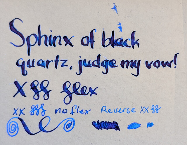 The same top-down photo but under a mix of UV and visible light.  The flex writing at the top is glowing dark blue and some lighter blue around its edges and in areas inside.  The no flex writing is glowing a bit brighter and more evenly  The reverse writing is glowing very brightly and evenly.