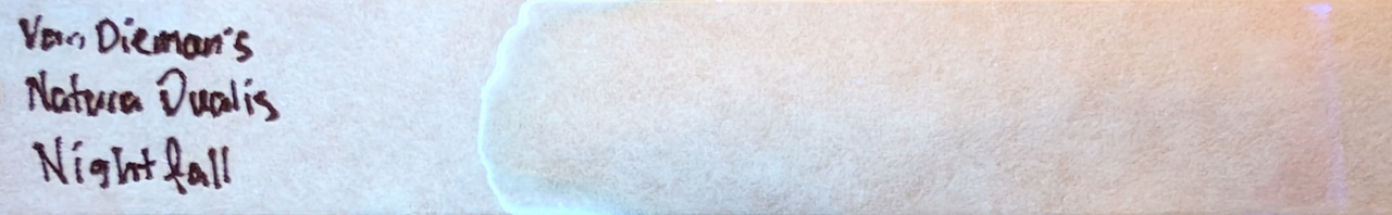Photo of chromatography paper under UV light.