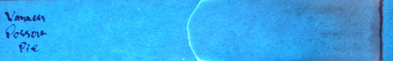 Photo of chromatography paper under UV light.
