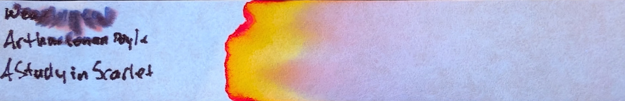 Photo of chromatography paper under UV light.