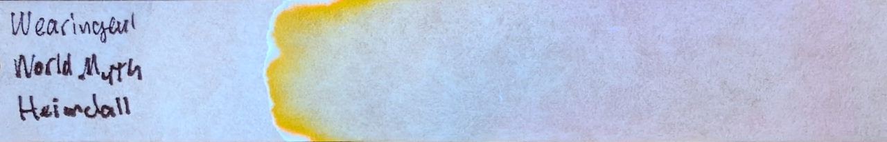 Photo of chromatography paper under UV light.